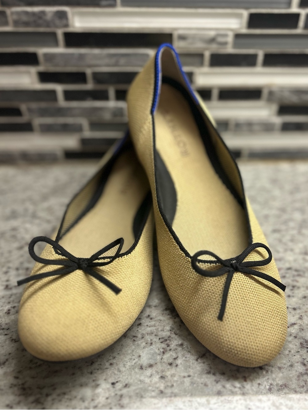 Rothy's Tan/cream Ballet Flats with Black Bow Trim and Blue Piping size 8